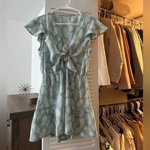 Gently worn green romper with floral detail from Aria Rose